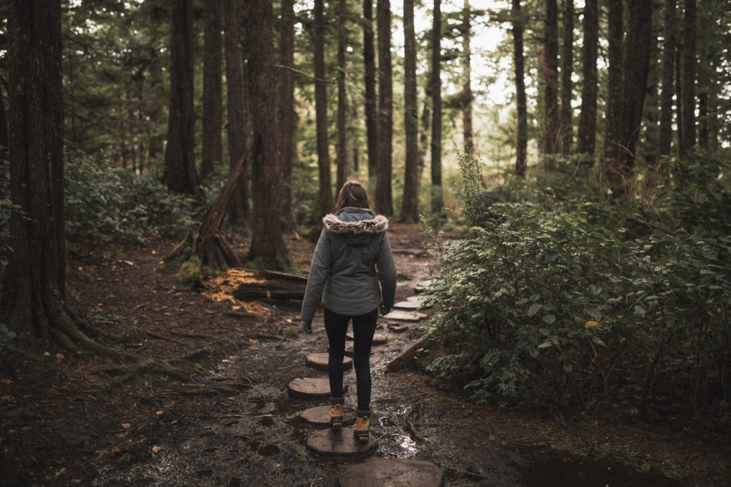 Girl walking through forest