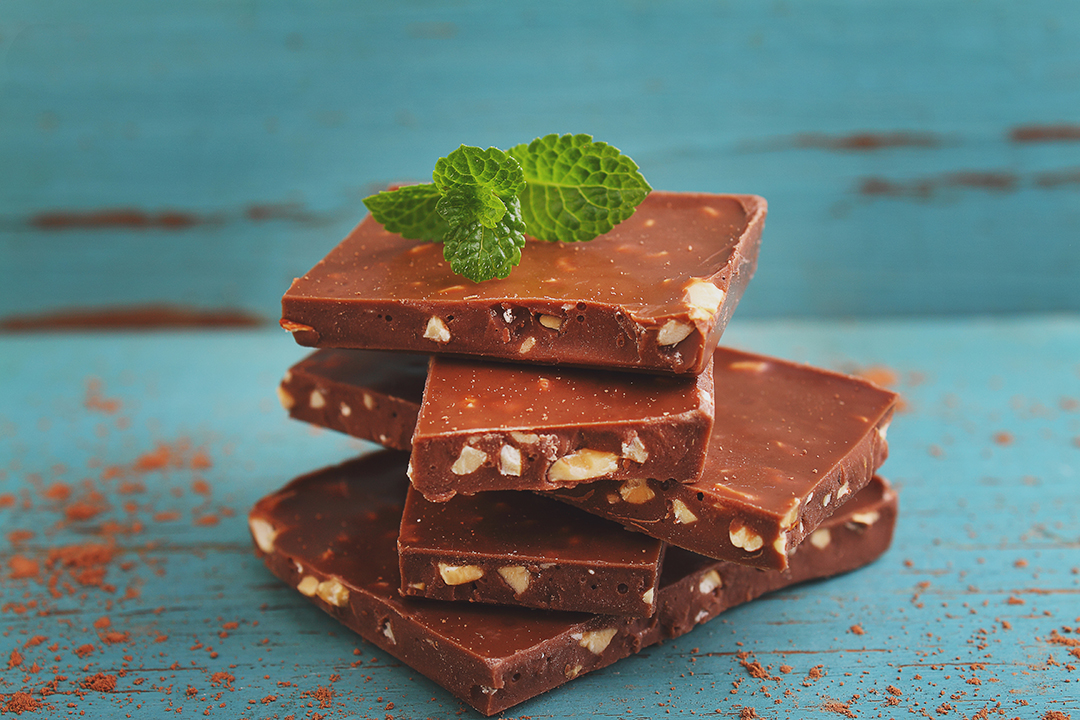 pieces of milk chocolate with nuts decorated with mint