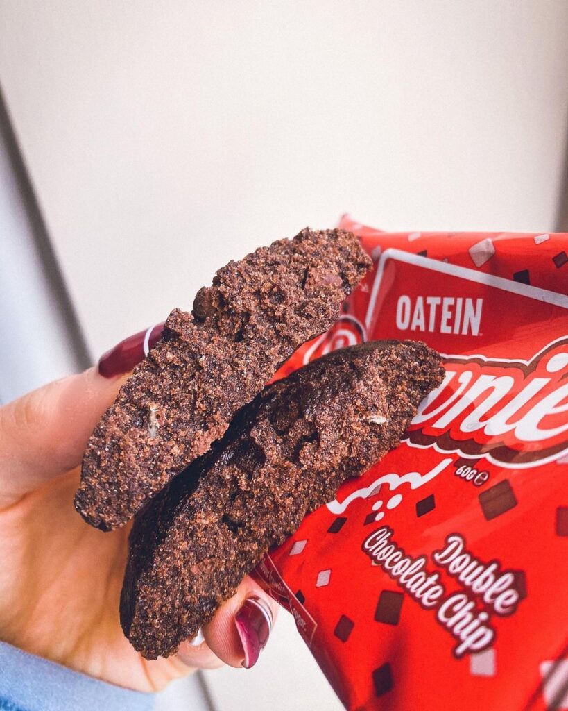 Chocolatey vegan protein brownie cut in half showing a gooey centre