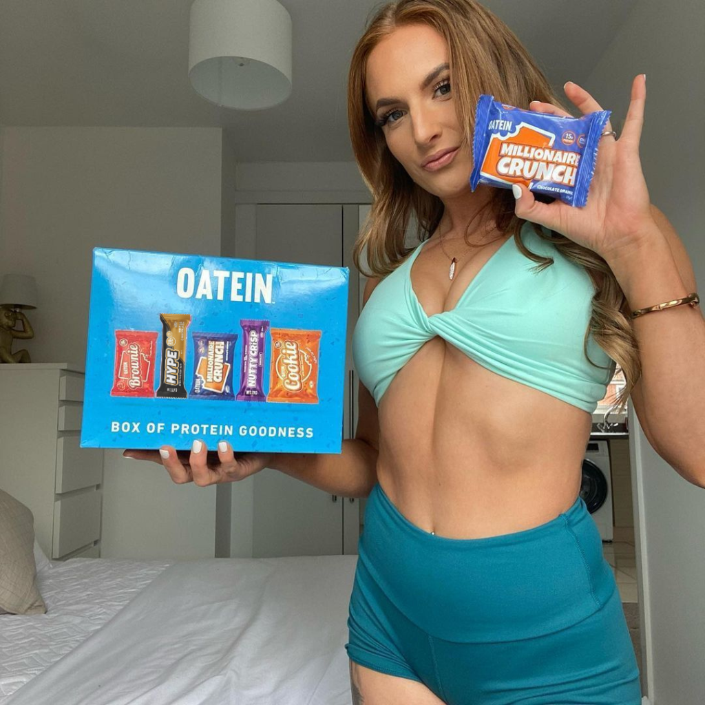 Our ambassador holding up a vegan protein bundle and vegan millionaire slice 